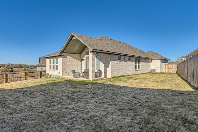 rear view of house with a patio, a lawn, and central air condition unit