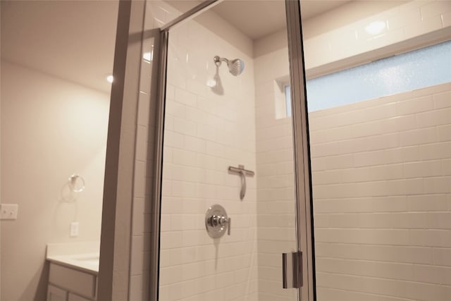 bathroom featuring vanity and an enclosed shower