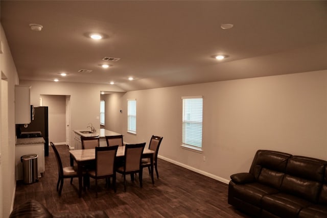 dining room with dark hardwood / wood-style flooring and sink