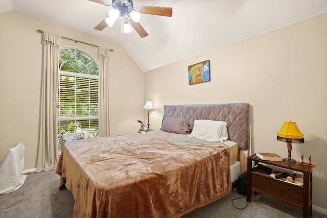 carpeted bedroom with ceiling fan and vaulted ceiling