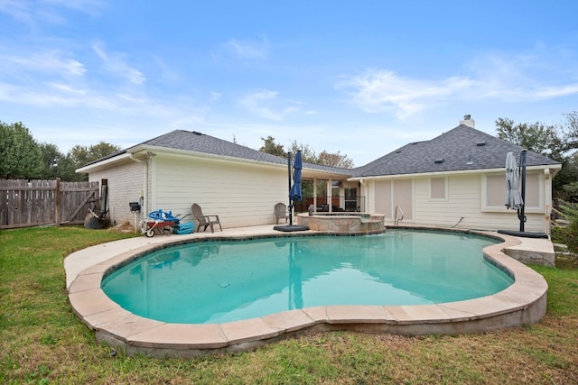 view of swimming pool with a patio, a yard, and an in ground hot tub