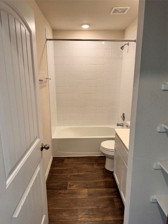 full bathroom featuring toilet, vanity, tiled shower / bath, and hardwood / wood-style flooring