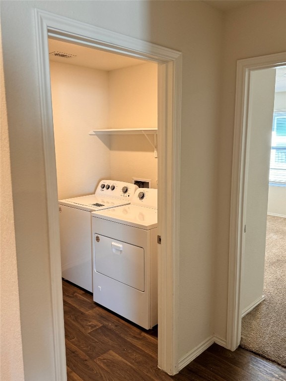 laundry area featuring dark hardwood / wood-style floors and washer and clothes dryer