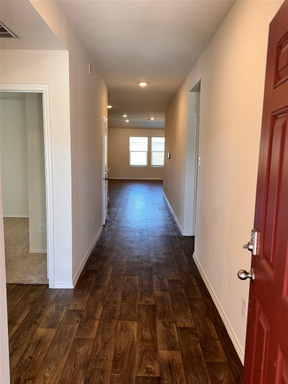 corridor with dark hardwood / wood-style floors