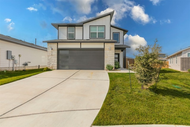 view of front of home featuring a garage and a front yard