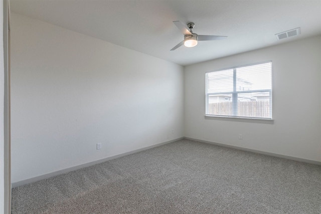 carpeted spare room with ceiling fan