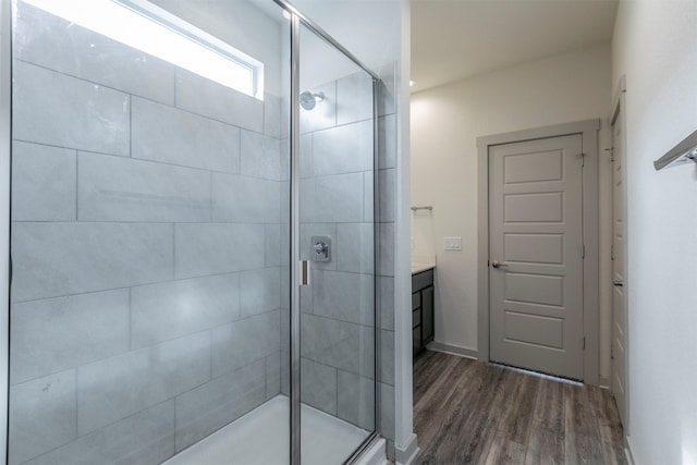 bathroom with vanity, wood-type flooring, and walk in shower