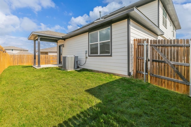 view of side of home featuring a lawn and central AC unit