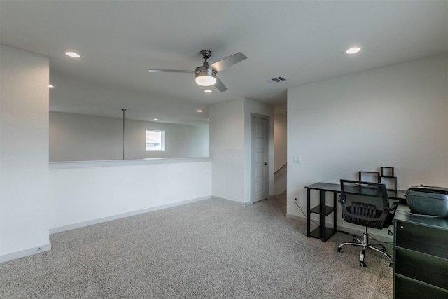 carpeted home office with ceiling fan