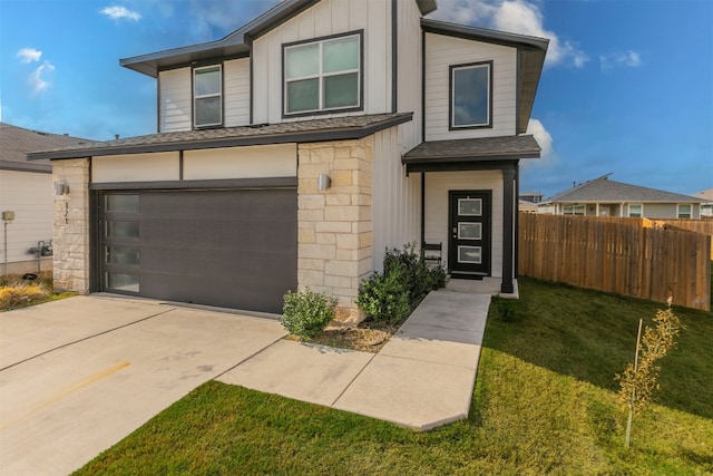 view of front of house with a front lawn and a garage