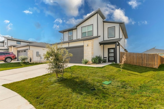 view of front of property featuring a front yard and a garage