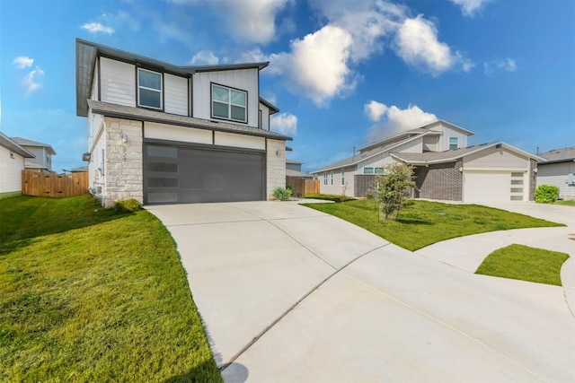 view of front of property featuring a garage and a front lawn