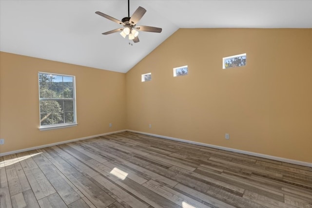 unfurnished room featuring high vaulted ceiling, hardwood / wood-style flooring, and ceiling fan