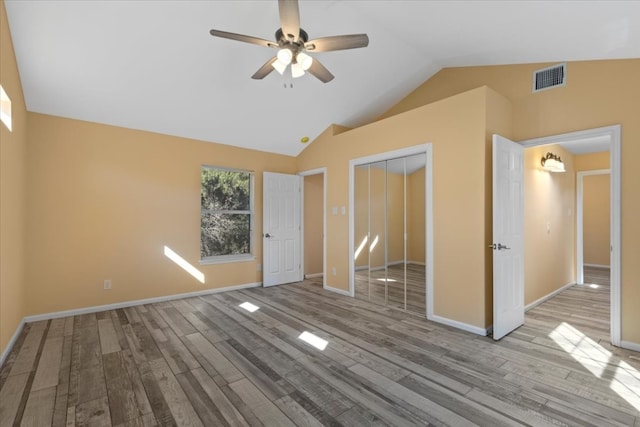 interior space featuring light wood-type flooring, lofted ceiling, and ceiling fan