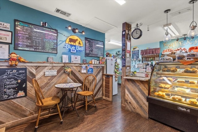 bar with dark hardwood / wood-style flooring