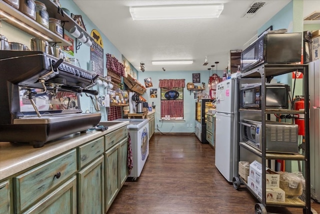 kitchen featuring green cabinetry, dark wood-type flooring, and white appliances