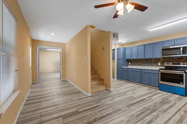 kitchen featuring tasteful backsplash, stainless steel appliances, light hardwood / wood-style floors, blue cabinets, and ceiling fan