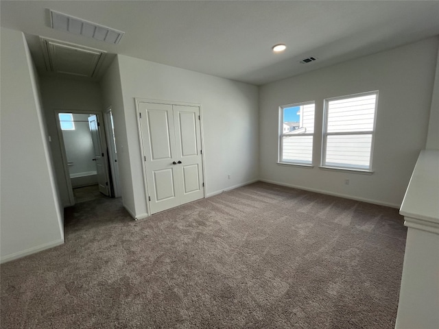 unfurnished bedroom with a closet and carpet flooring