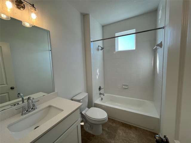 full bathroom featuring tiled shower / bath, toilet, and vanity