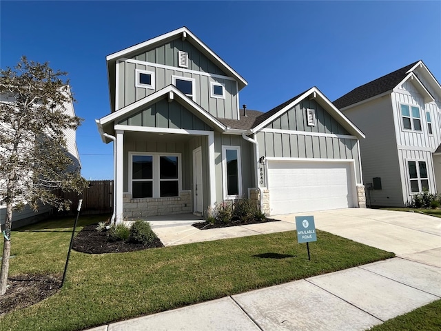 view of front of property featuring a garage and a front yard