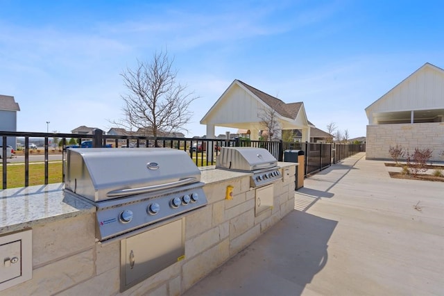 view of patio with area for grilling and a grill