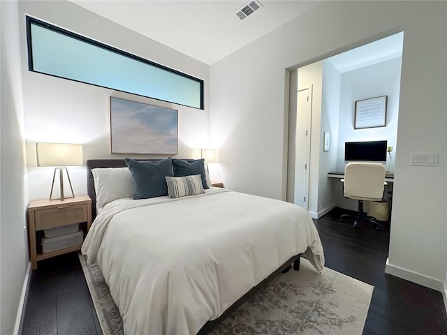 800 Embassy Dr Unit 530, Austin, TX 78702 - bedroom featuring dark wood-style flooring, baseboards, and an office area