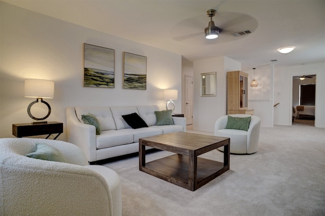 carpeted living room featuring ceiling fan