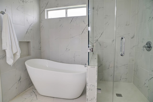 bathroom featuring tile walls and shower with separate bathtub