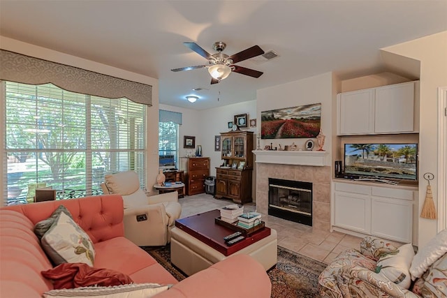 2000 Cullen Ave Unit 9, Austin, TX 78757 - living room featuring a ceiling fan, a tile fireplace, and light tile patterned flooring
