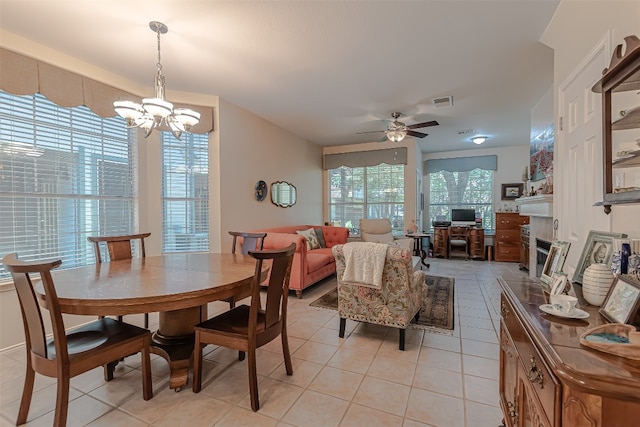 dining room featuring ceiling fan with notable chandelier and light tile patterned floors