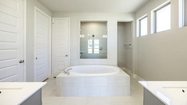 121 La Venta Loop, Liberty Hill, TX 78642 - bathroom featuring vanity, a garden tub, tile patterned floors, and a tile shower
