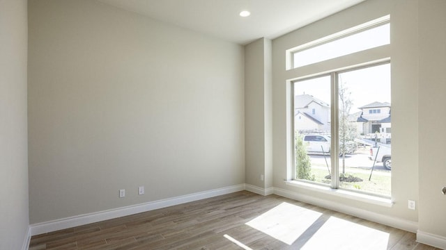 121 La Venta Loop, Liberty Hill, TX 78642 - empty room with plenty of natural light, wood finished floors, baseboards, and recessed lighting