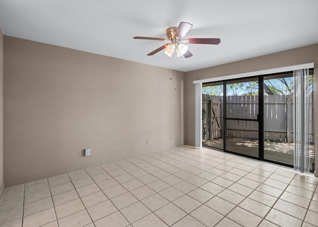 tiled spare room featuring ceiling fan