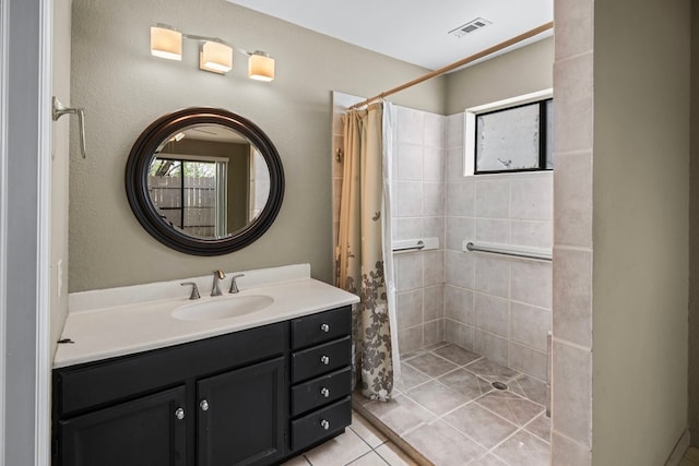 bathroom featuring vanity, tile patterned flooring, and curtained shower