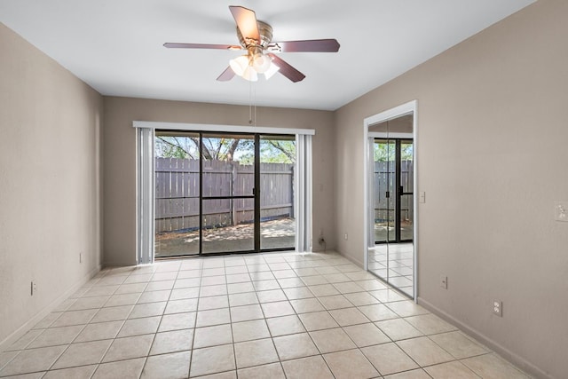 tiled empty room with ceiling fan