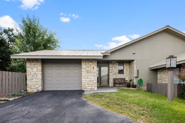 view of front of property featuring a garage and a front lawn