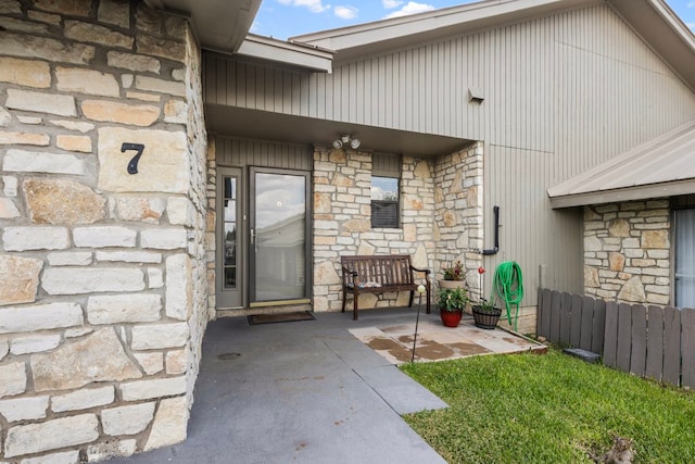 view of exterior entry featuring a patio