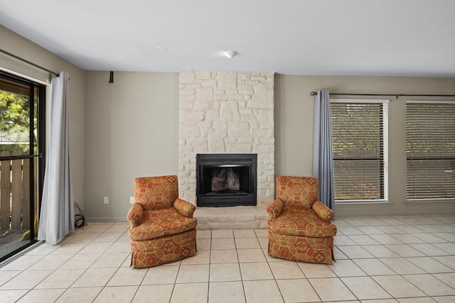 living area featuring a fireplace and light tile patterned floors