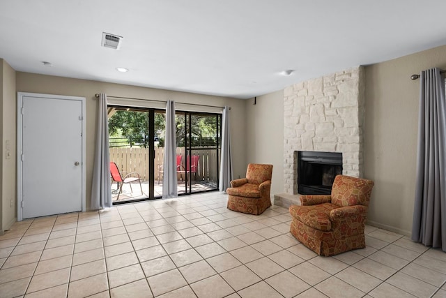 living area featuring light tile patterned flooring and a fireplace