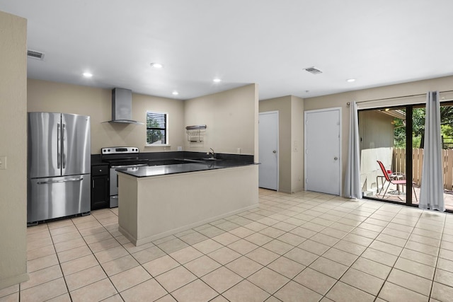 kitchen with stainless steel appliances, wall chimney exhaust hood, plenty of natural light, and sink