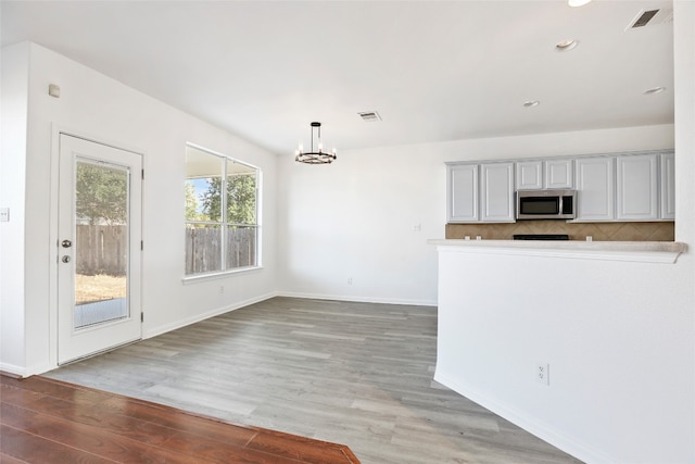 kitchen featuring an inviting chandelier, decorative light fixtures, and wood-type flooring