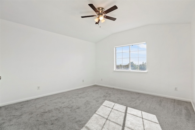 carpeted spare room featuring ceiling fan and vaulted ceiling