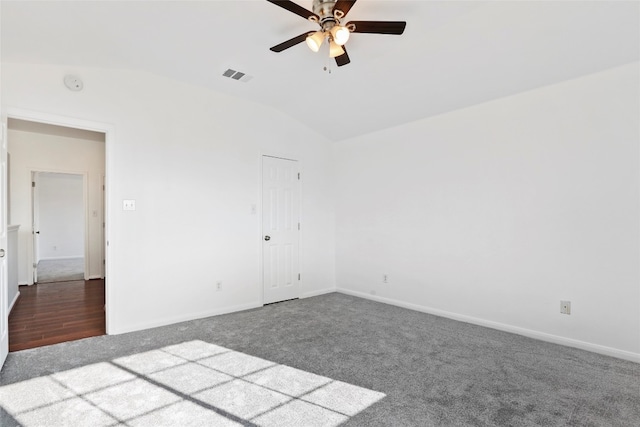 empty room featuring ceiling fan, lofted ceiling, and dark hardwood / wood-style floors