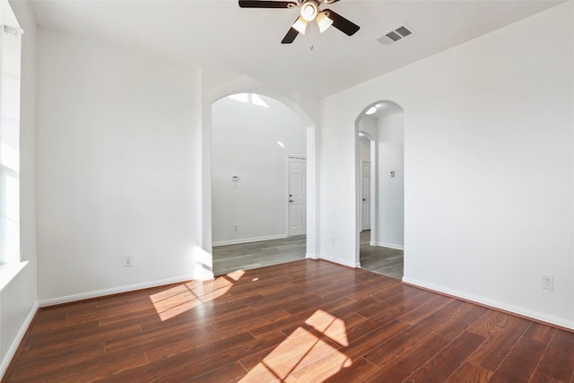 spare room featuring ceiling fan and dark hardwood / wood-style floors