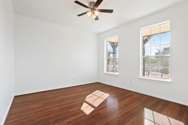 spare room featuring dark wood-type flooring and ceiling fan