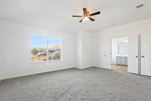 spare room featuring light colored carpet and ceiling fan