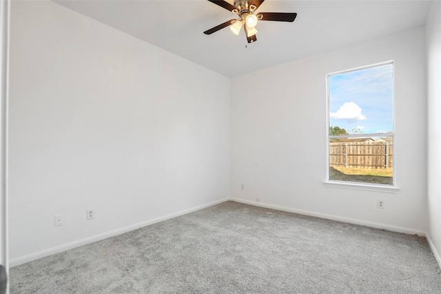 empty room featuring carpet floors and ceiling fan