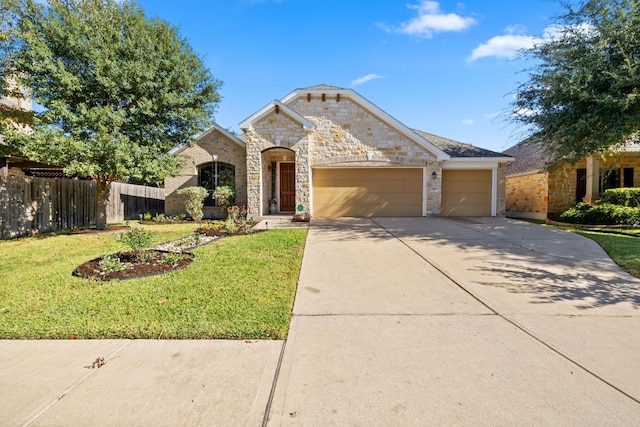 view of front of property with a garage and a front lawn