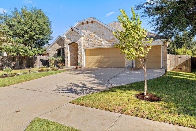 view of front facade with a garage and a front yard