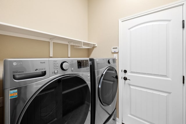 clothes washing area featuring washer and clothes dryer